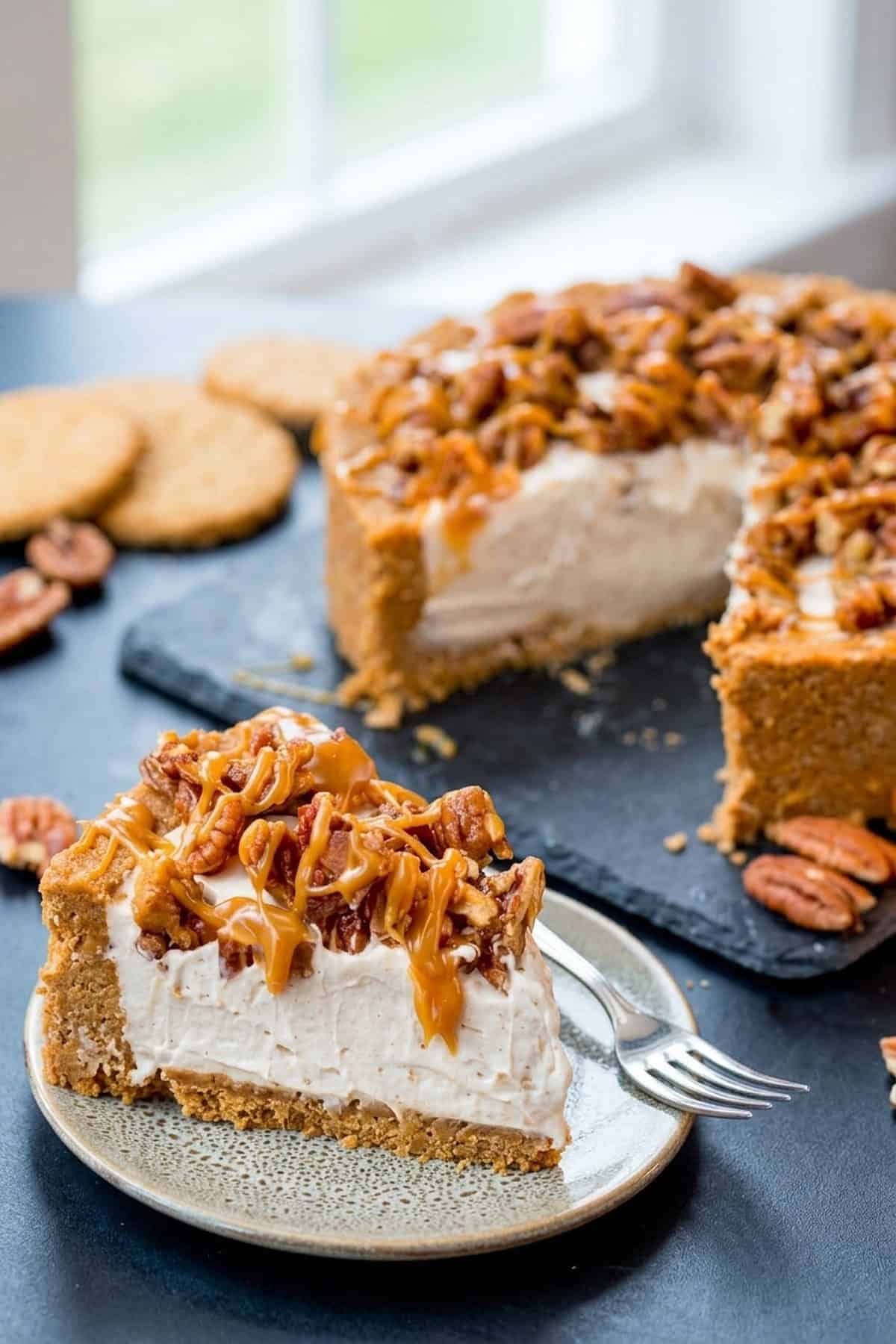 No-Bake-Cheesecake mit Wintergewürzen, Pekannüssen und Salzkaramell serviert im rustikalen Teller bei sanftem Tageslicht